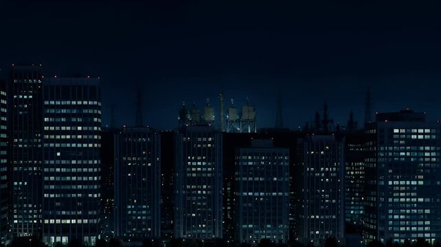 Night cityscape silhouette with illuminated windows and dark sky