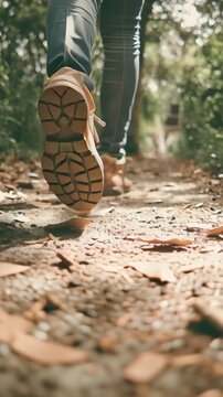 Person walking on a forest trail, concept of an active lifestyle and enjoying nature