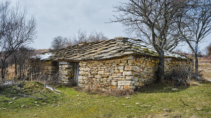 Old, abandoned, ruined mountain hut built from rocks only, traditional building style in Serbian history