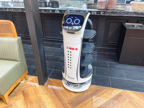 10 February 2026, Istanbul, Turkey: Autonomous restaurant service robot waiter for food delivery in dining interior for menu, advertising, poster and background design