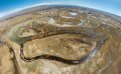 Obraz premium Aerial view over a wetland landscape with rivers and lakes on the pampas in the vicinity of the village of Gobernador Gregores, Santa Cruz Province Argentina