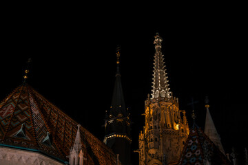 Fisherman's Bastion in Budapest illuminated at night. The historic structure features turrets and arches, surrounded by a quiet plaza. © VasylisaDvoichenkova