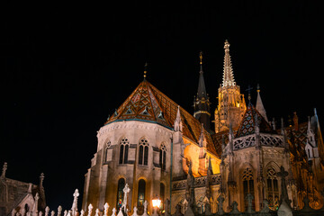 Fisherman's Bastion in Budapest illuminated at night. The historic structure features turrets and arches, surrounded by a quiet plaza. © VasylisaDvoichenkova
