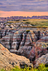 Big Badlands Overlook stands in Badlands National Park, South Dakota, USA. Scenic view features...
