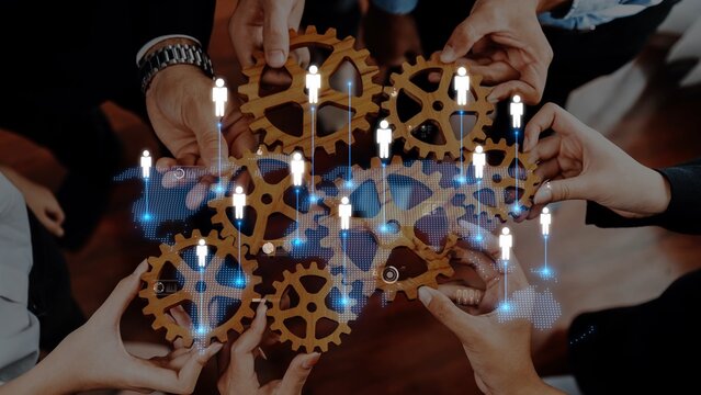 A creative representation of teamwork, showcasing hands uniting over gears, symbolizing cooperation and innovation in a modern business context with digital connections. Raster
