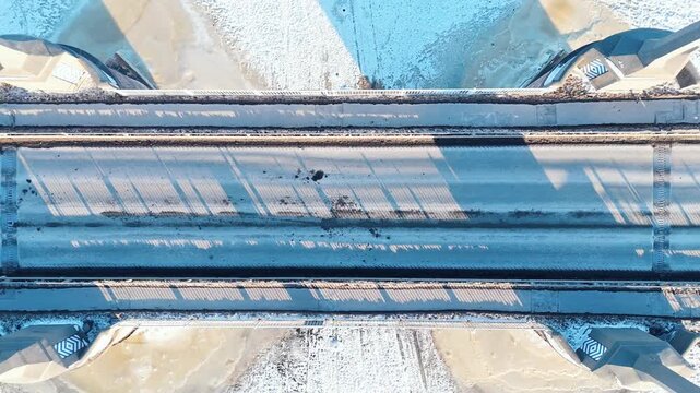 Top Down Aerial of P&auml;rnu City Center Bridge in Winter - Estonia Traffic Drone View