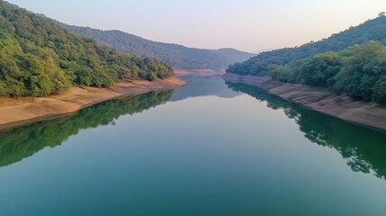 Fototapeta premium Serene River Reflecting Lush Green Mountains Under Soft Light in a Peaceful Landscape
