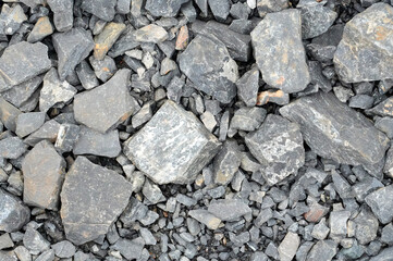 Pile of stone pebbles on the ground as background texture