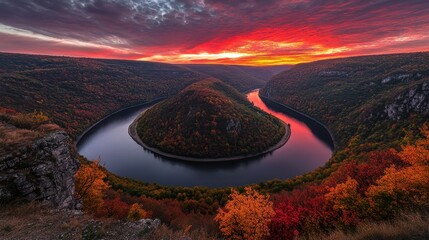 Fiery autumn sunset paints a dramatic sky over a winding river canyon showcasing nature's vibrant spectacle