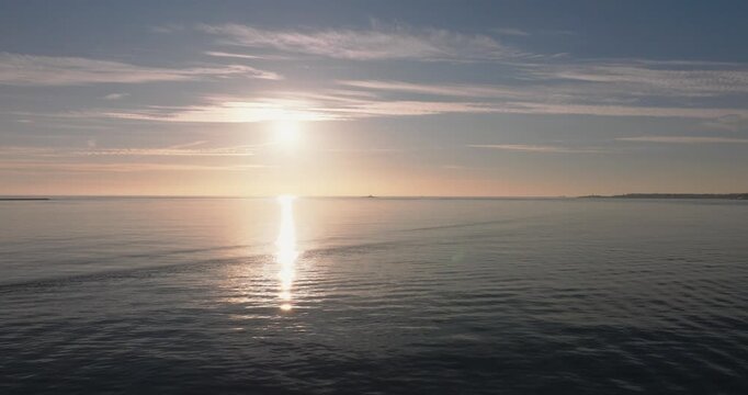 Aerial drone view golden hour towards Atlantic Ocean horizon and Bugio lighthouse, Estoril and Cascais