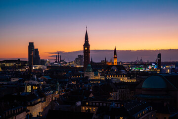 Obraz premium Copenhagen city skyline at twilight, aerial view of urban architecture during blue hour, Denmark.
