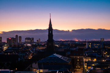Naklejka premium Copenhagen city skyline at twilight, aerial view of urban architecture during blue hour, Denmark.