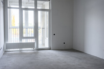 Fototapeta premium Empty room interior with large windows and concrete floor, natural light