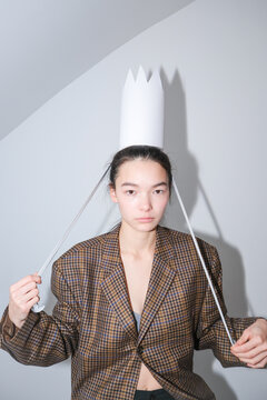 Artistic portrait featuring a model wearing a paper crown 