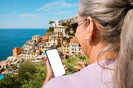 Woman holding a blank screen phone in Cinque Terre