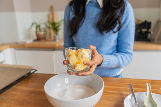 Woman Holding Butter In Glass Bowl