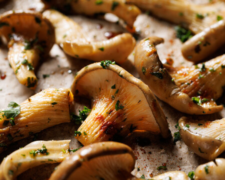 Fresh oyster mushrooms in a herbal marinade ready to be baked, focus of the mushroom inside