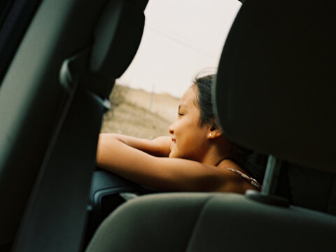 Girl looking out car window