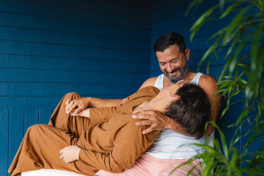 Adult couple sharing a moment of complicity on the porch