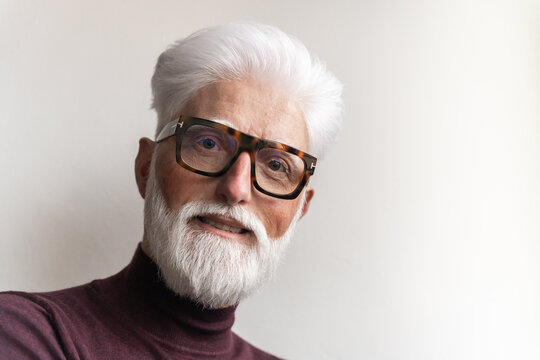 Closeup Portrait Of Senior Man With Glasses And White Beard