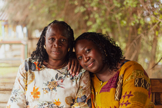 Daughter leaning on her elderly mother's shoulder