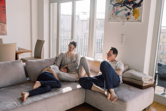 Family Relaxing in Sunlit Modern Living Room