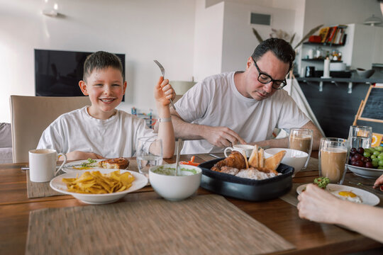 Family eating lunch together at dining table