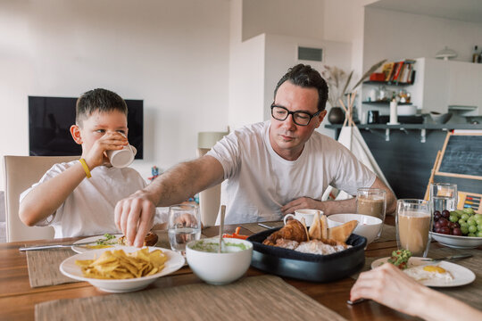 Family eating lunch together at dining table