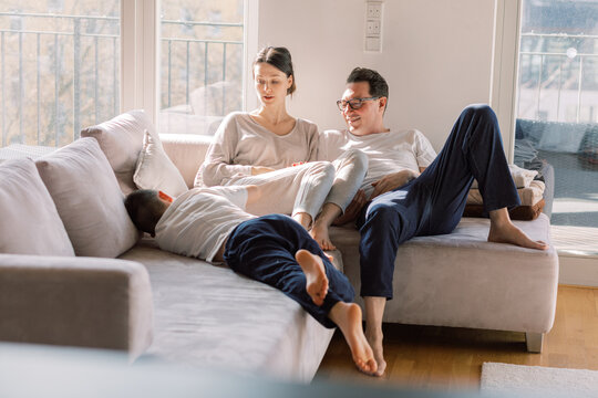 Family relaxing together on a sunlit couch