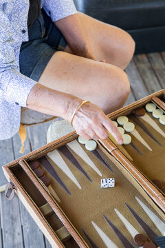 Close-up of a hand playing backgammon on a table
