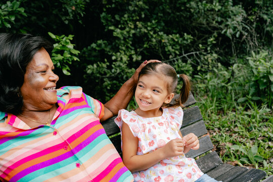grandfather walking in the park with his beloved granddaughter