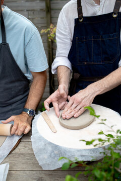 a young man makes pots for banzai