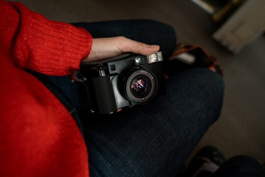 Woman photographer holding vintage film camera