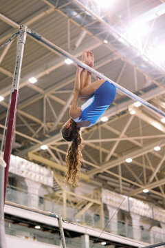 Upside-Down Gymnast Holding the Bar