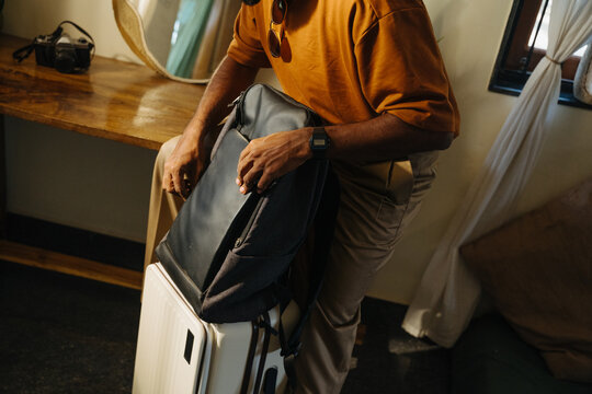 Traveler in Brown Coat Packing Luggage