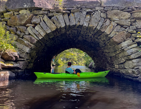 Boy in Kayak on river fishing trip 