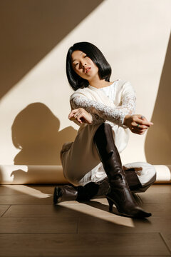 Asian woman in trendy outfit in studio