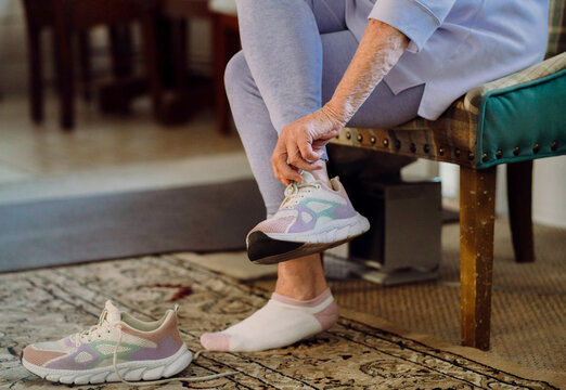  Elderly Woman Putting on Athletic Shoe