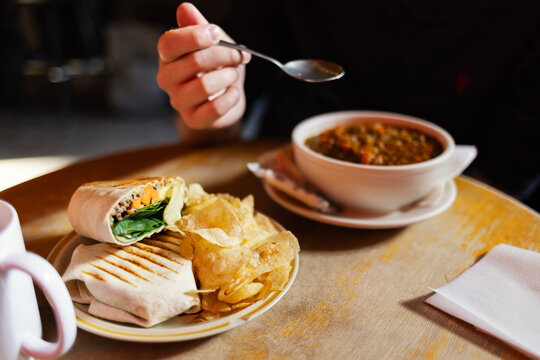 Vegan wrap and lentil soup on cafe table in Chicago