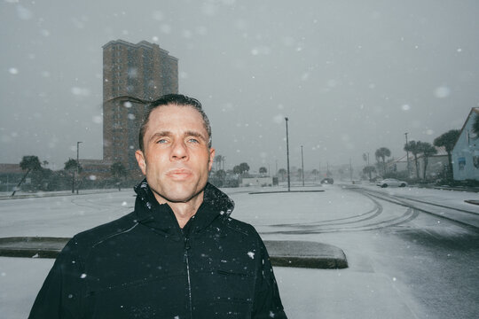 Portrait o Man in Empty Parking Lot During Winter Storm