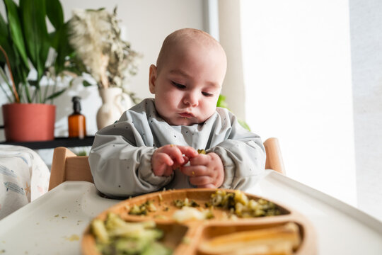 Baby eating broccoli