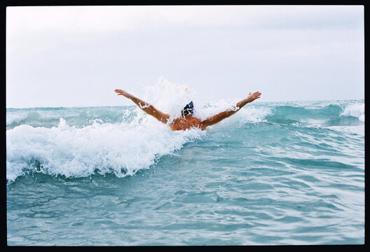 Swimmer gliding through ocean waves 