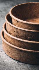 Fototapeta premium Biodegradable food packaging mockup featuring stack of round brown eco friendly containers with natural texture suitable for sustainable takeaway or restaurant use