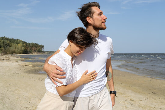 a young couple with  walking near the sea