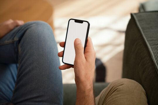 Anonymous man using phone with blank screen .