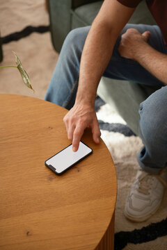 Anonymous man scrolling on blank screen .