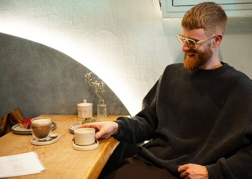 Young man drinking tea in cafe 