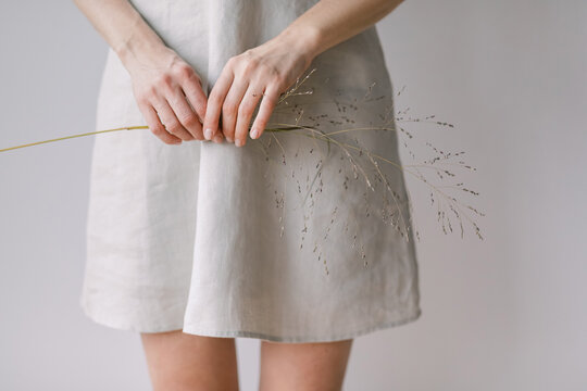 Hands Holding Dried Grass with Linen Dress