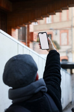 Man up his phone in urban setting