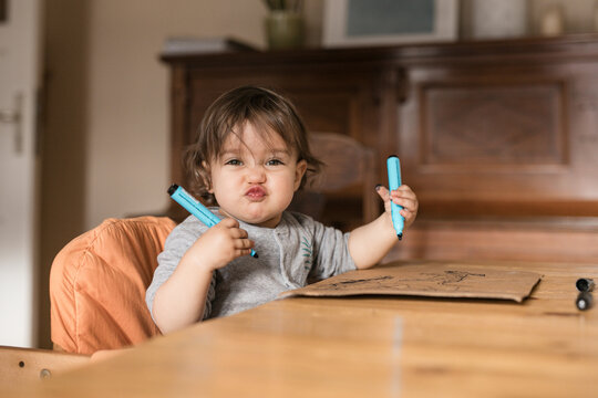 Toddler Making Faces with Markers